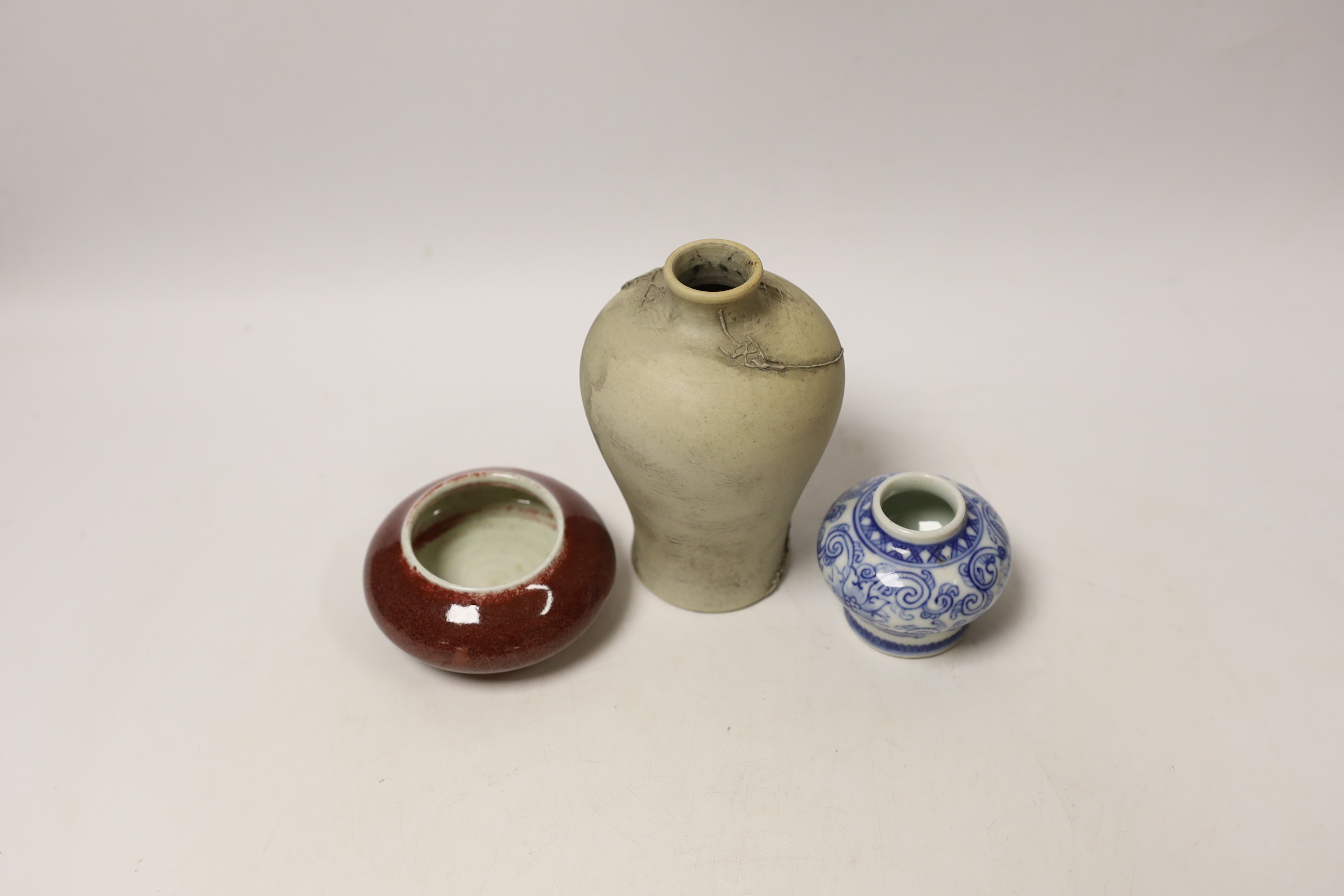 A Chinese sang de boeuf brush washer, a miniature blue and white vase and another vase, largest 14cm high